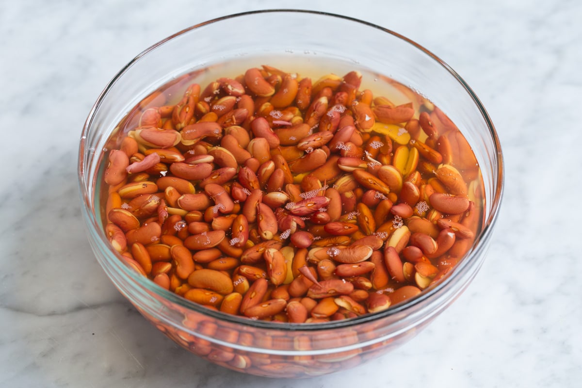 Perfect Red Beans and Rice - delicious Louisiana style comfort food at it's best! #redbeans #rice #southern #recipe #dinner Red beans soaking in a glass bowl with water.