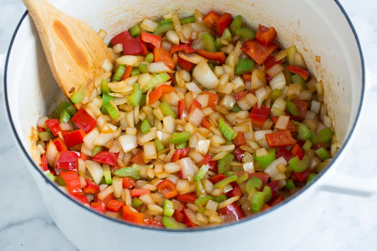 Perfect Red Beans and Rice - delicious Louisiana style comfort food at it's best! #redbeans #rice #southern #recipe #dinner Sautéing bell pepper, celery, onion and garlic in a pot.