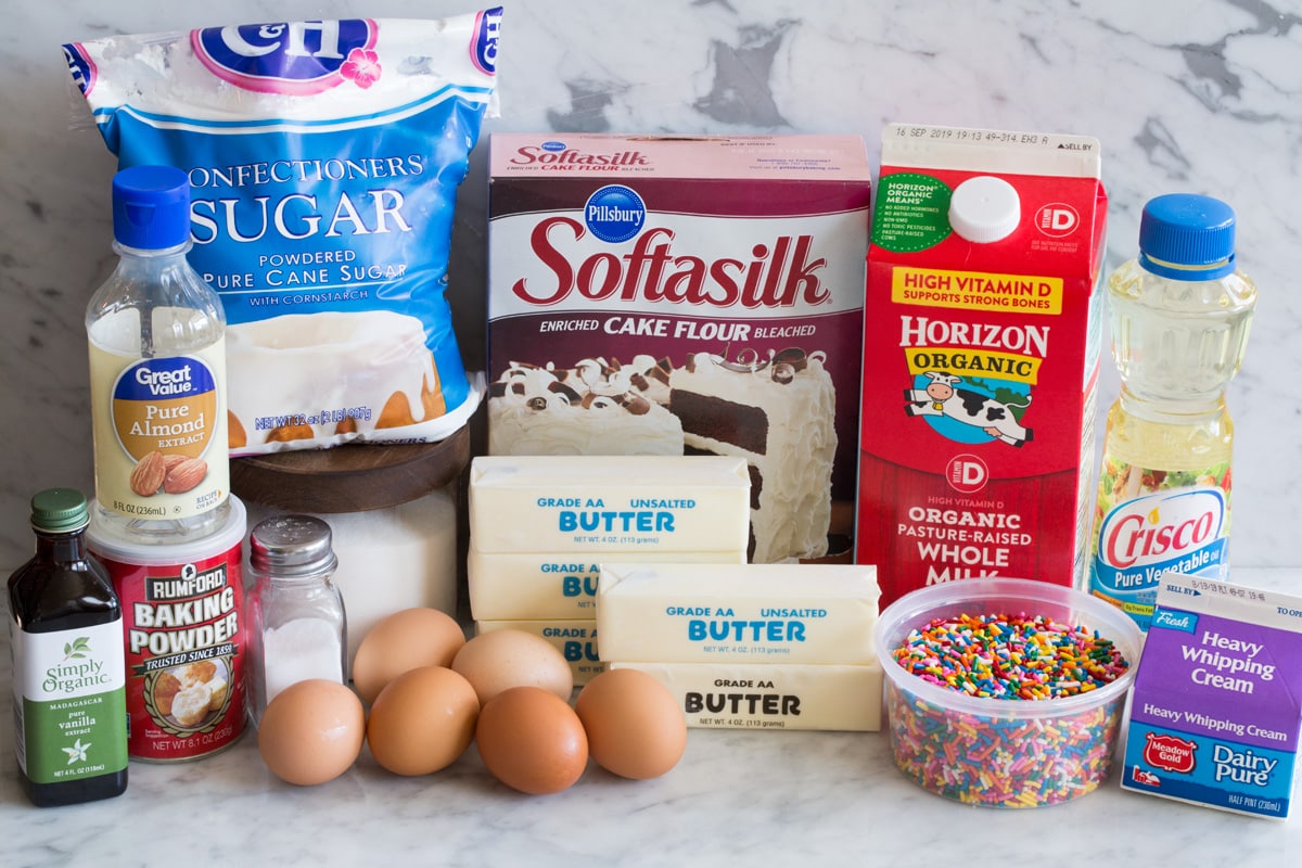 Funfetti Birthday Cake Funfetti Birthday Cake ingredients including cake flour, butter, sugar, eggs, egg whites, vanilla, almond extract, milk, sprinkles, vegetable oil, cream, salt, baking powder and powdered sugar.