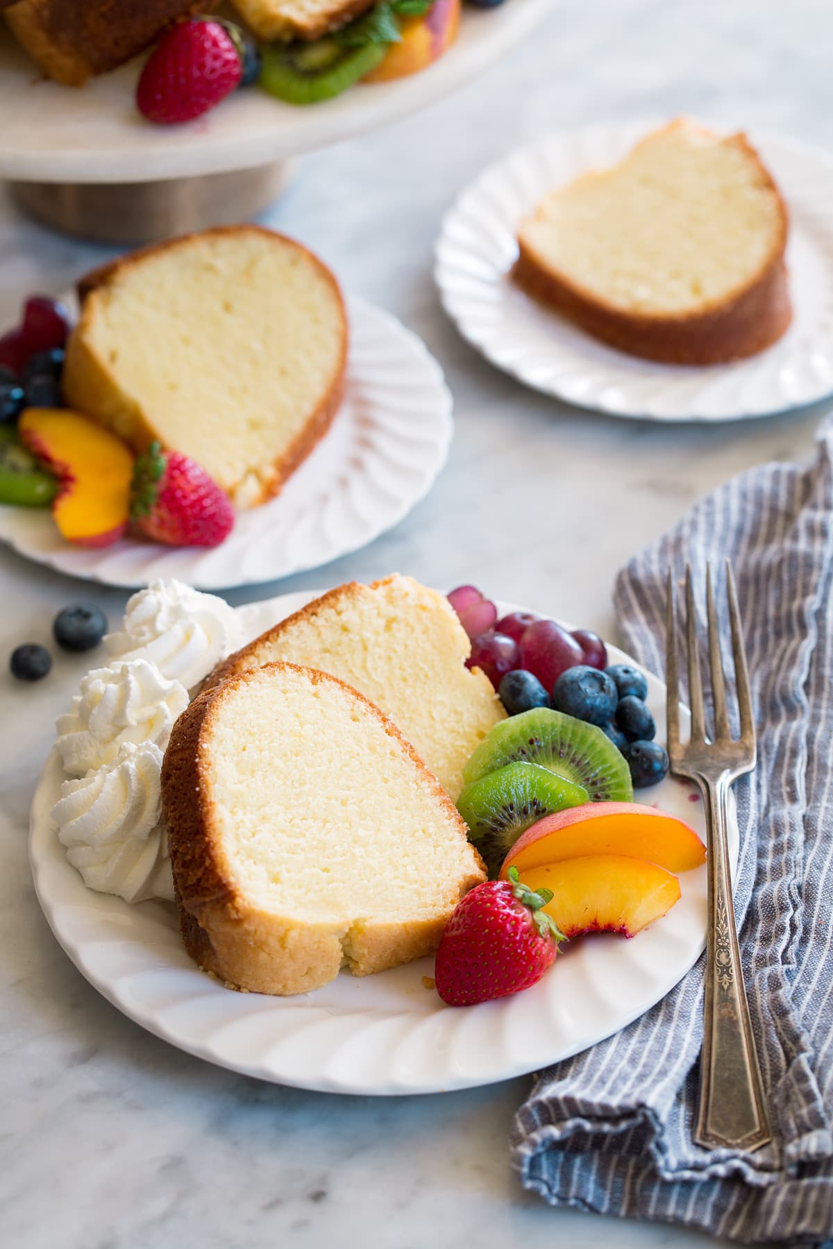 Pound Cake Three white dessert plates with slices of homemade pound cake.