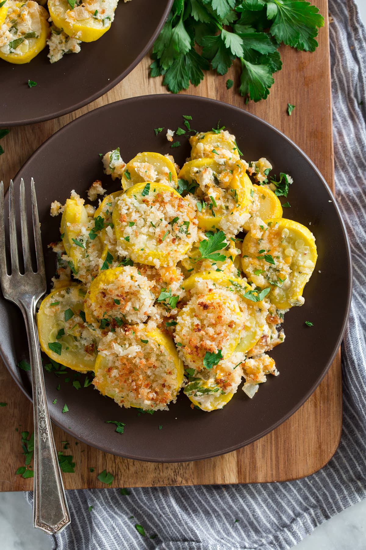 Squash Casserole Cheesy squash casserole on a brown plate.