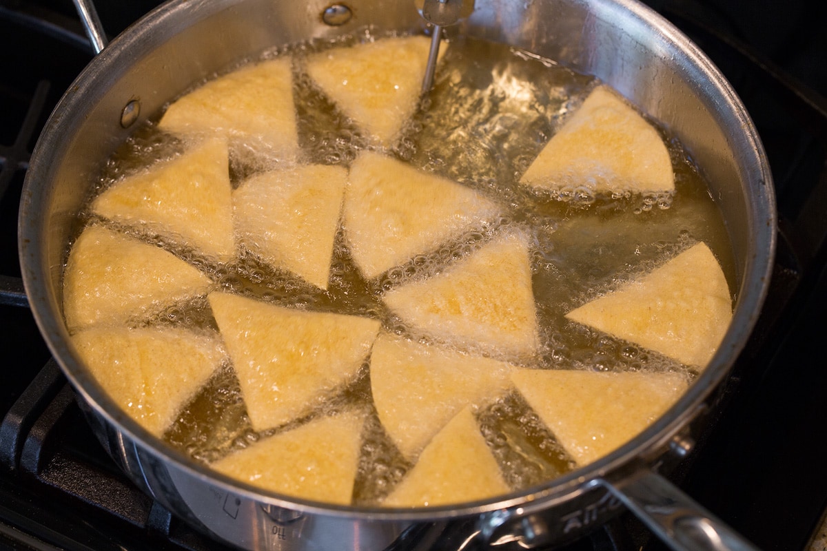 Homemade Tortilla Chips Frying tortilla chips in vegetable oil.