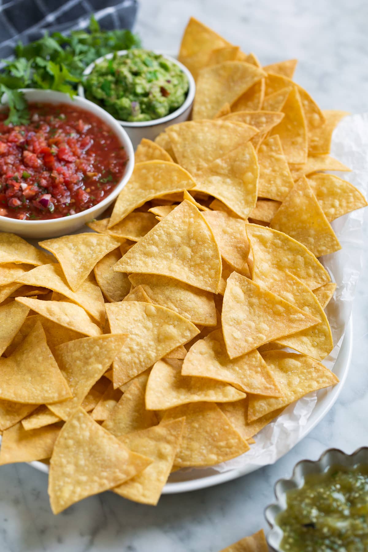 Homemade Tortilla Chips Serving dish full of tortilla chips and dips.