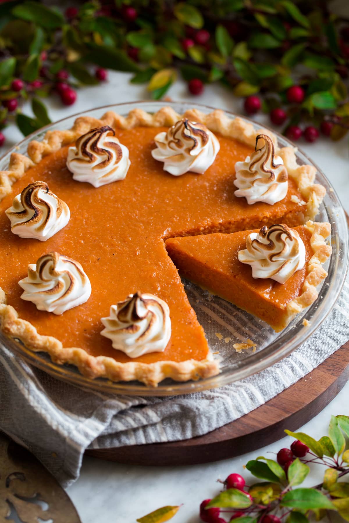 Perfect Sweet Potato Pie Whole sweet potato pie with a slice cut. It's topped with toasted marshmallow swirls.