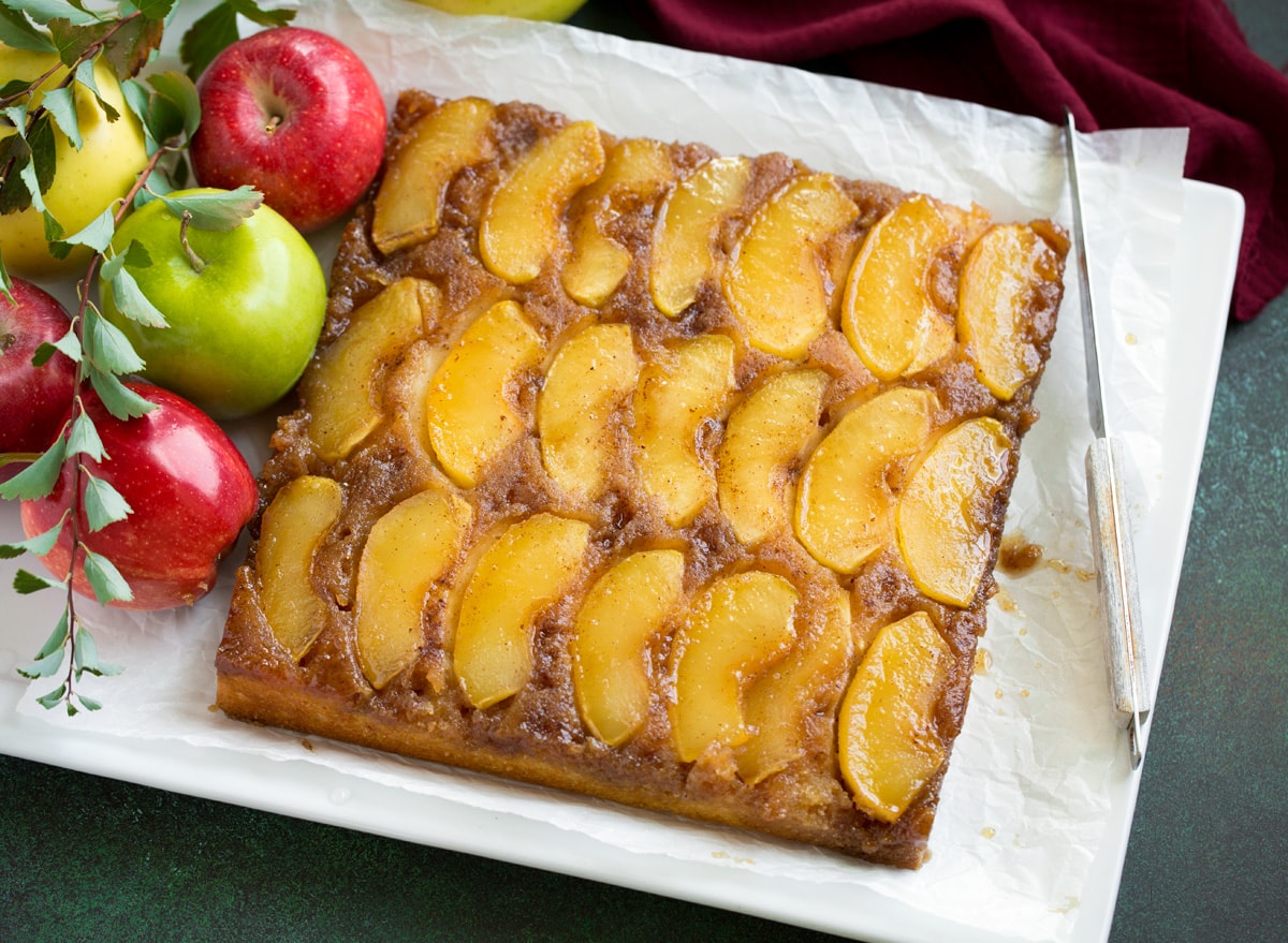 Apple Upside Down Cake Whole apple upside down cake on a white serving plater.