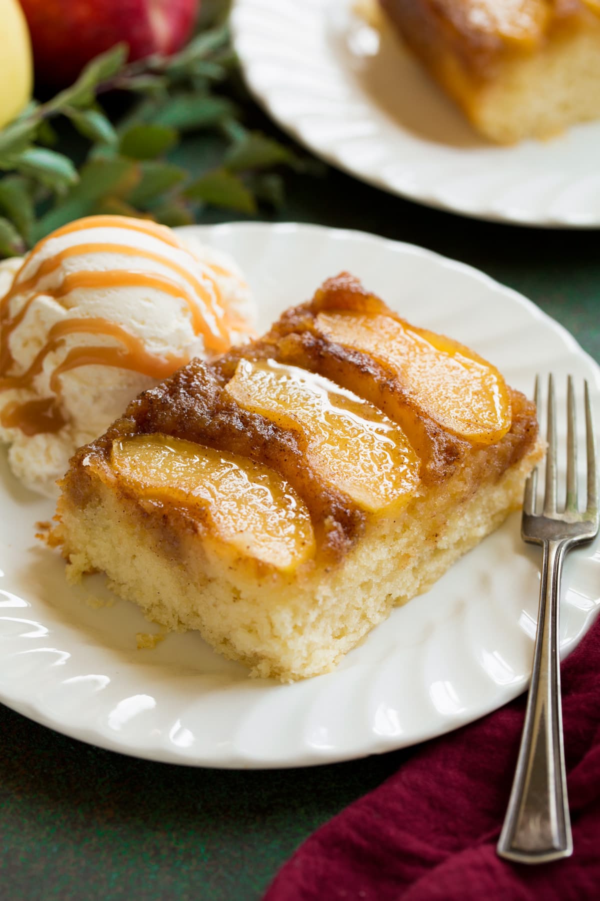 Apple Upside Down Cake Slice of apple upside down cake on a white dessert plate.
