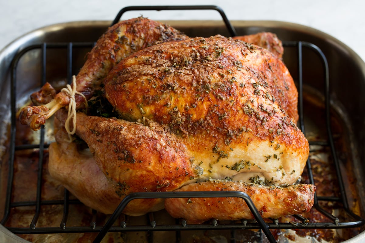 Roast Turkey - easy to follow recipe that turns out tender, juicy and full of flavor! A holiday staple! #turkey #thanksigiving Baked turkey in a roasting pan.