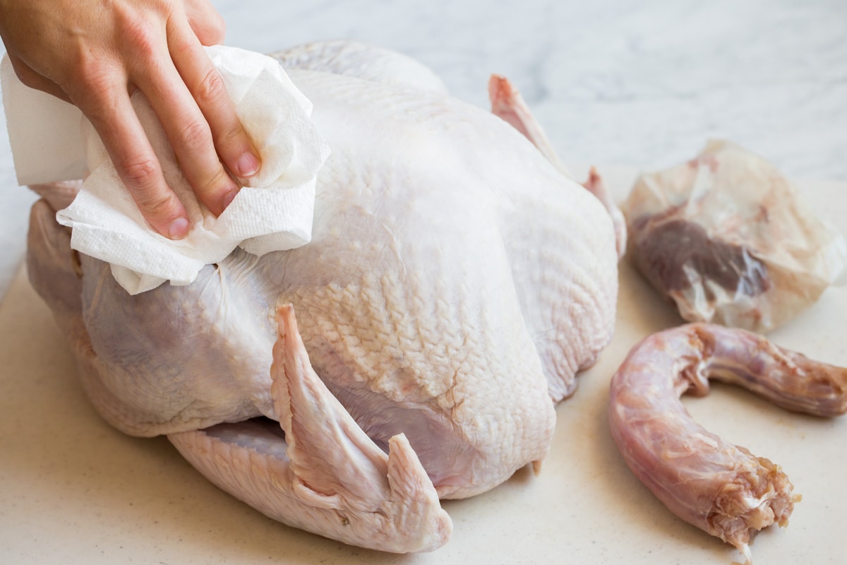 Roast Turkey - easy to follow recipe that turns out tender, juicy and full of flavor! A holiday staple! #turkey #thanksigiving Drying turkey with paper towels so butter adheres better and skin browns better.