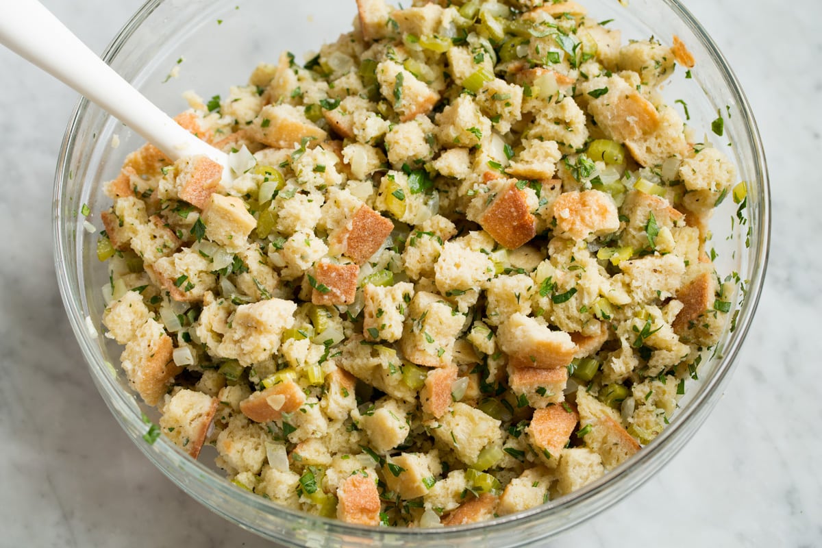 Stuffing Recipe - this is my FAVORITE stuffing! It's perfectly moistened in the center, browned and crisp on the edges and packed with butter and herb flavor. A fall staple! #stuffing #thanksgiving #sidedish #recipe Wet stuffing mixture after mixing in mixing bowl.