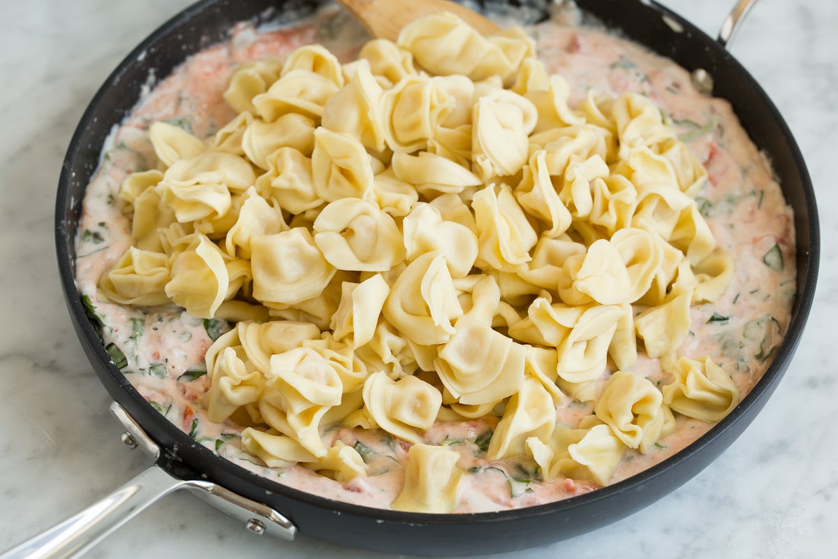 Creamy Spinach Tomato Tortellini Adding cooked cheese tortellini to pasta sauce