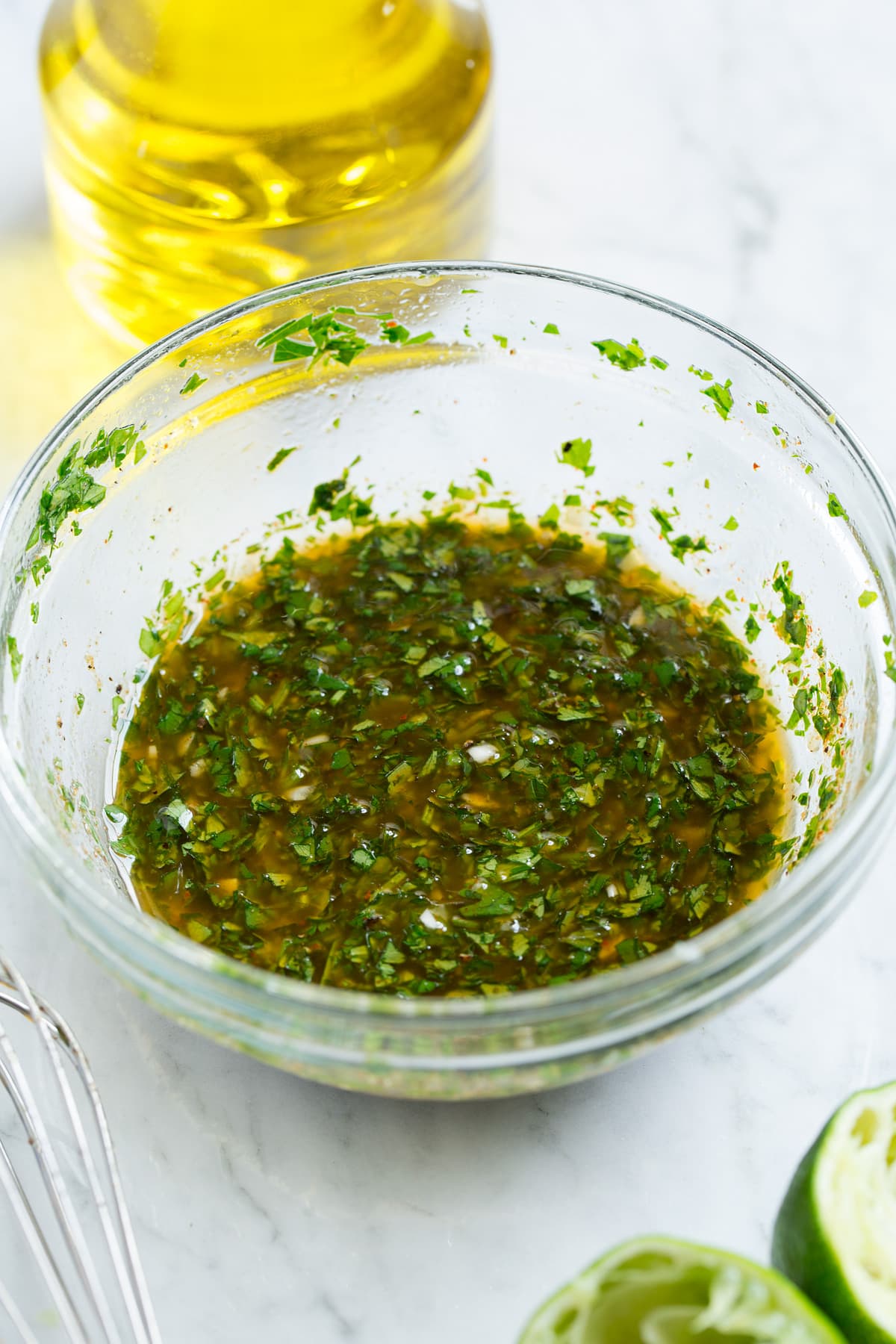 Black Bean and Corn Salad Cilantro Lime Vinaigrette shown in a glass mixing bowl after blending together. This is the dressing used for black bean salad.