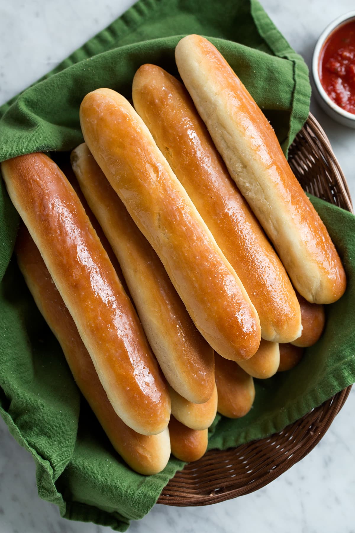 Breadsticks Recipe (Olive Garden Copycat) Overhead image of stack of breadsticks on basket.