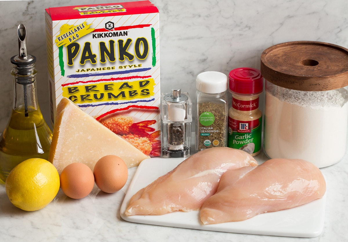 Parmesan Crusted Chicken Photo of ingredients in parmesan crusted chicken. Includes chicken breasts, panko bread crumbs, flour, eggs, garlic powder, Italian seasoning, lemon, parmesan, olive oil, salt and pepper.