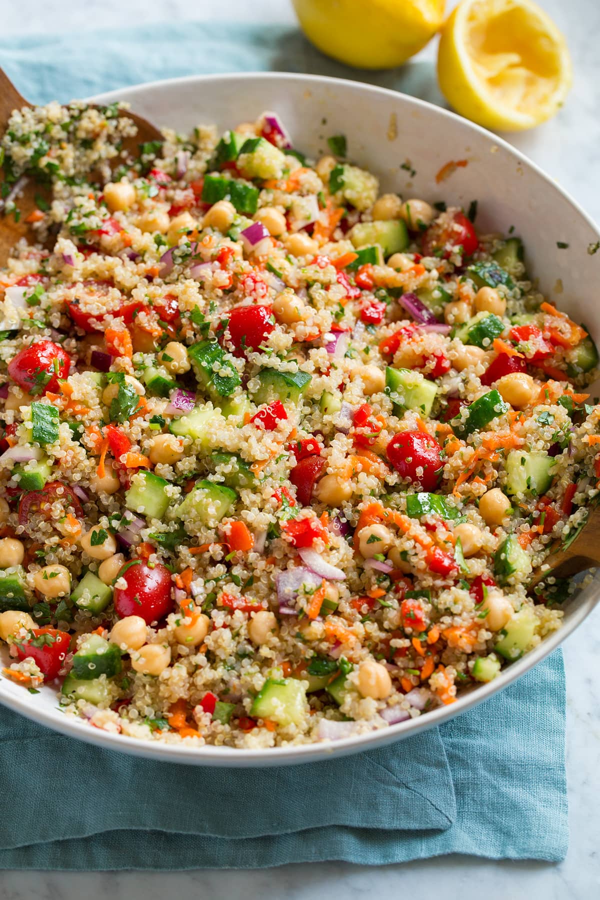 Quinoa Salad Healthy quinoa salad in a serving bowl. Salad shows quinoa, cucumber, tomatoes, carrots, red onion, chick peas and herbs.