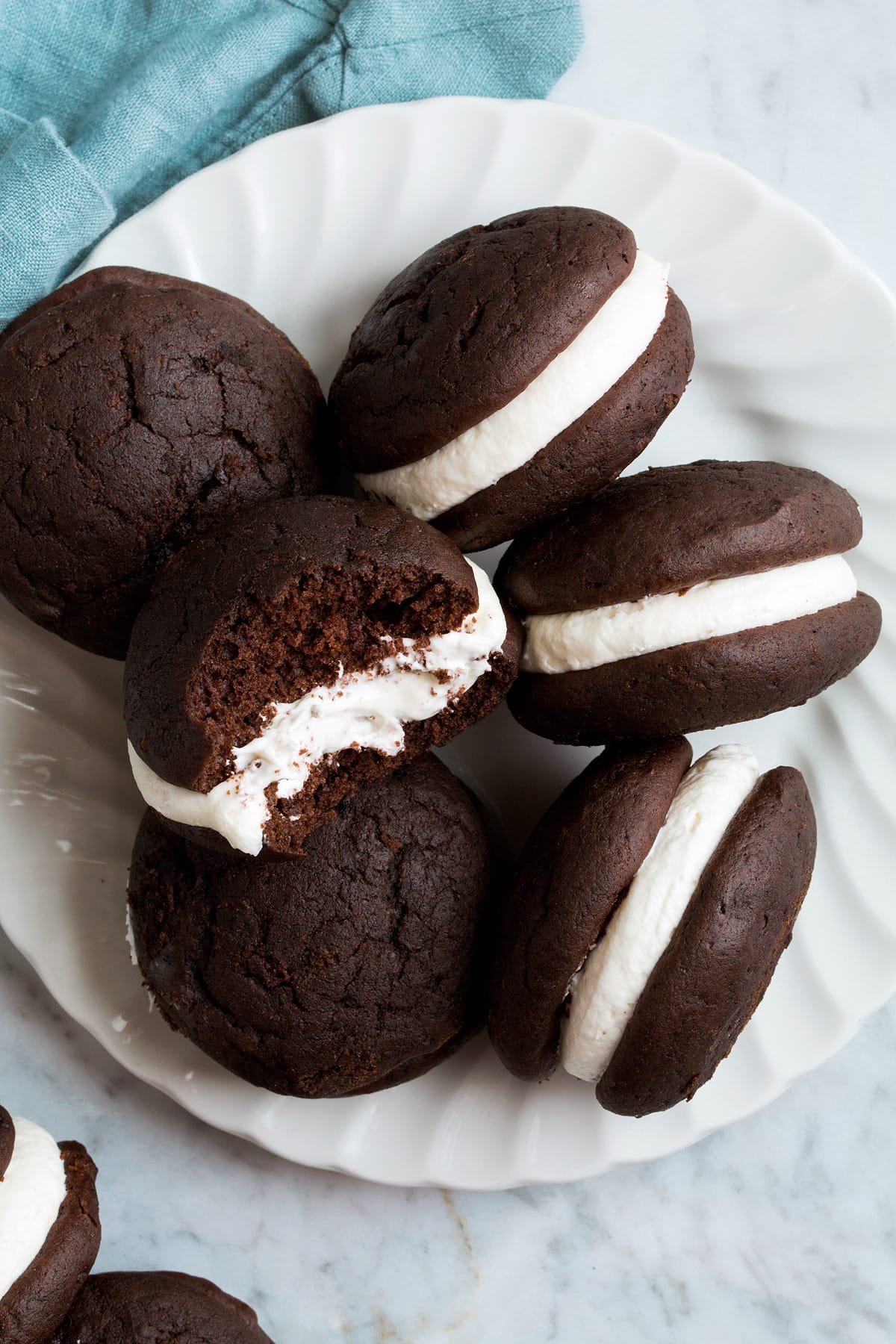 Whoopie Pies Overhead image of chocolate Whoopie Pies with one broken in half to show texture.
