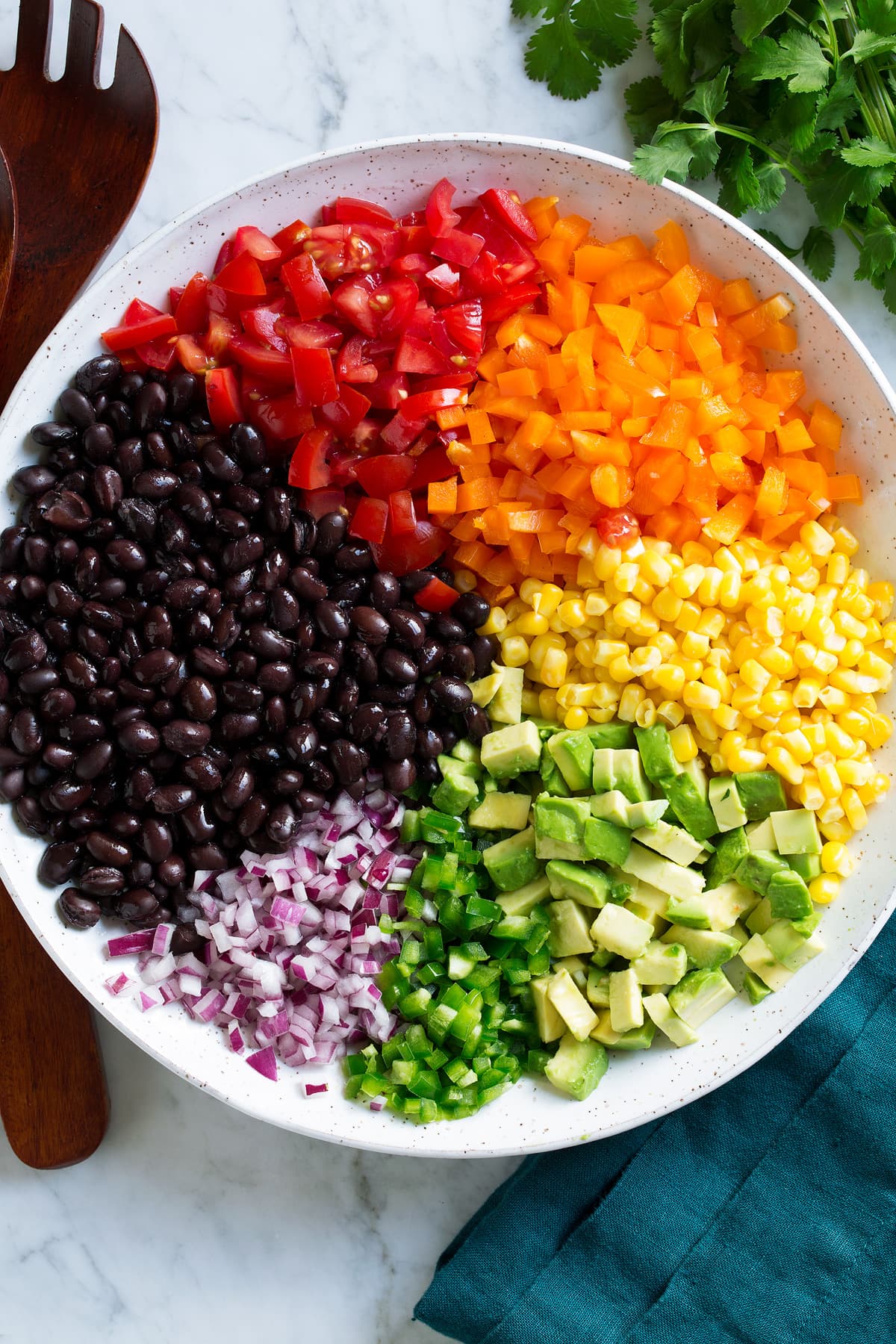 Black Bean and Corn Salad Black bean and corn salad ingredients in a mixing bowl before tossing together.