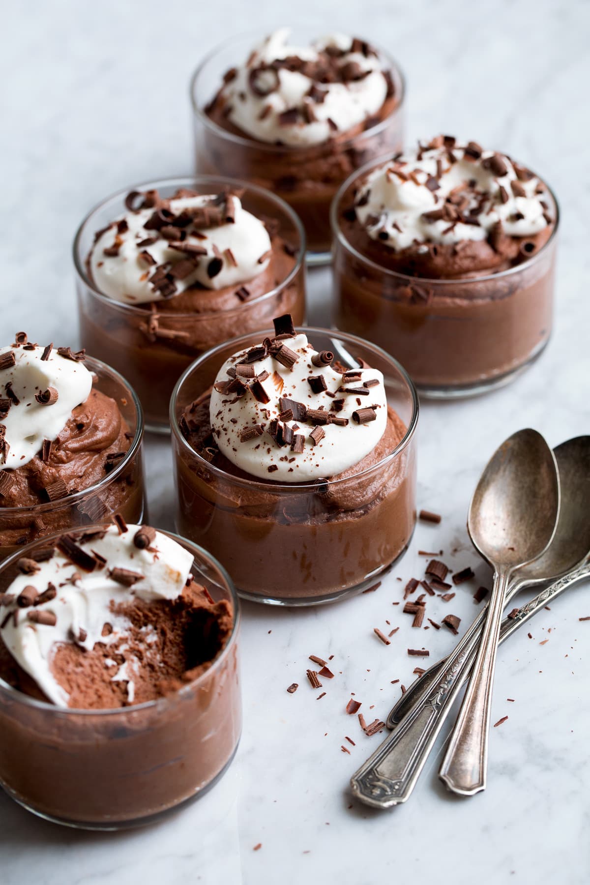 Chocolate Mousse 6 servings of chocolate mousse in small glass cups.