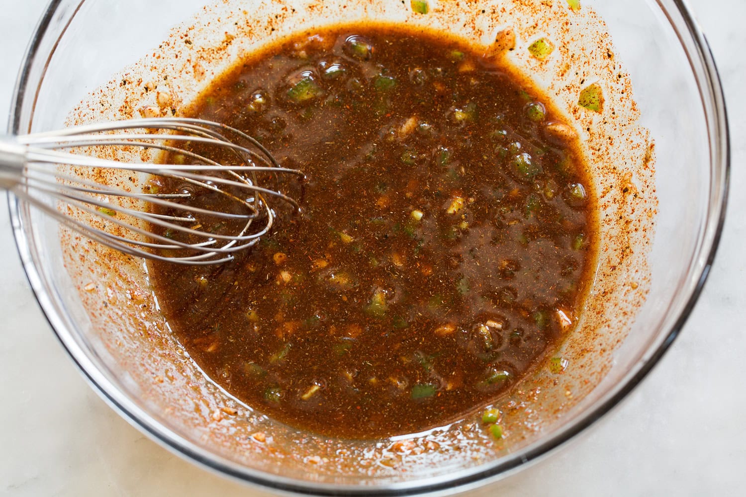 Chicken Fajitas Chicken fajita marinade shown after mixing in glass mixing bowl.