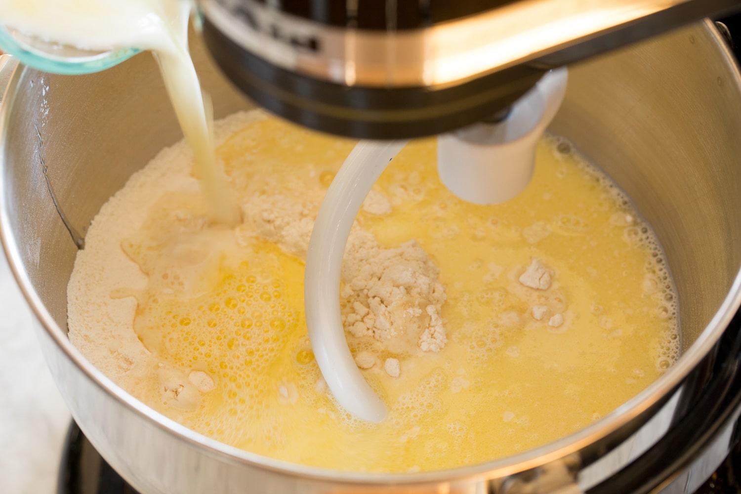 One Hour Dinner Rolls Dry and wet ingredients being mixed for dough.