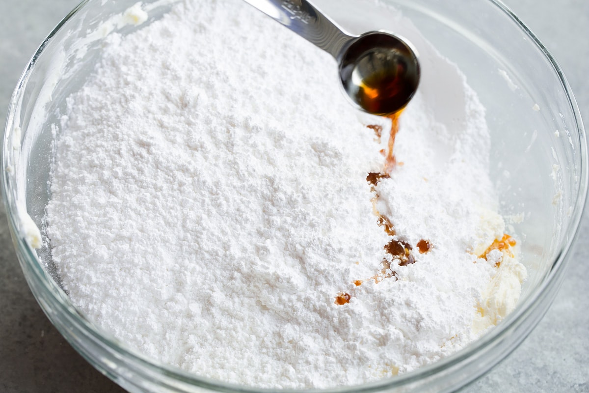 Cream Cheese Frosting Powdered sugar and vanilla added to mixing bowl with butter and cream cheese.
