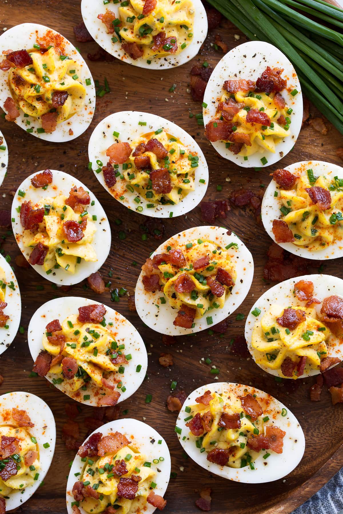 Best Deviled Eggs Garnished deviled eggs shown overhead with chives to the side.