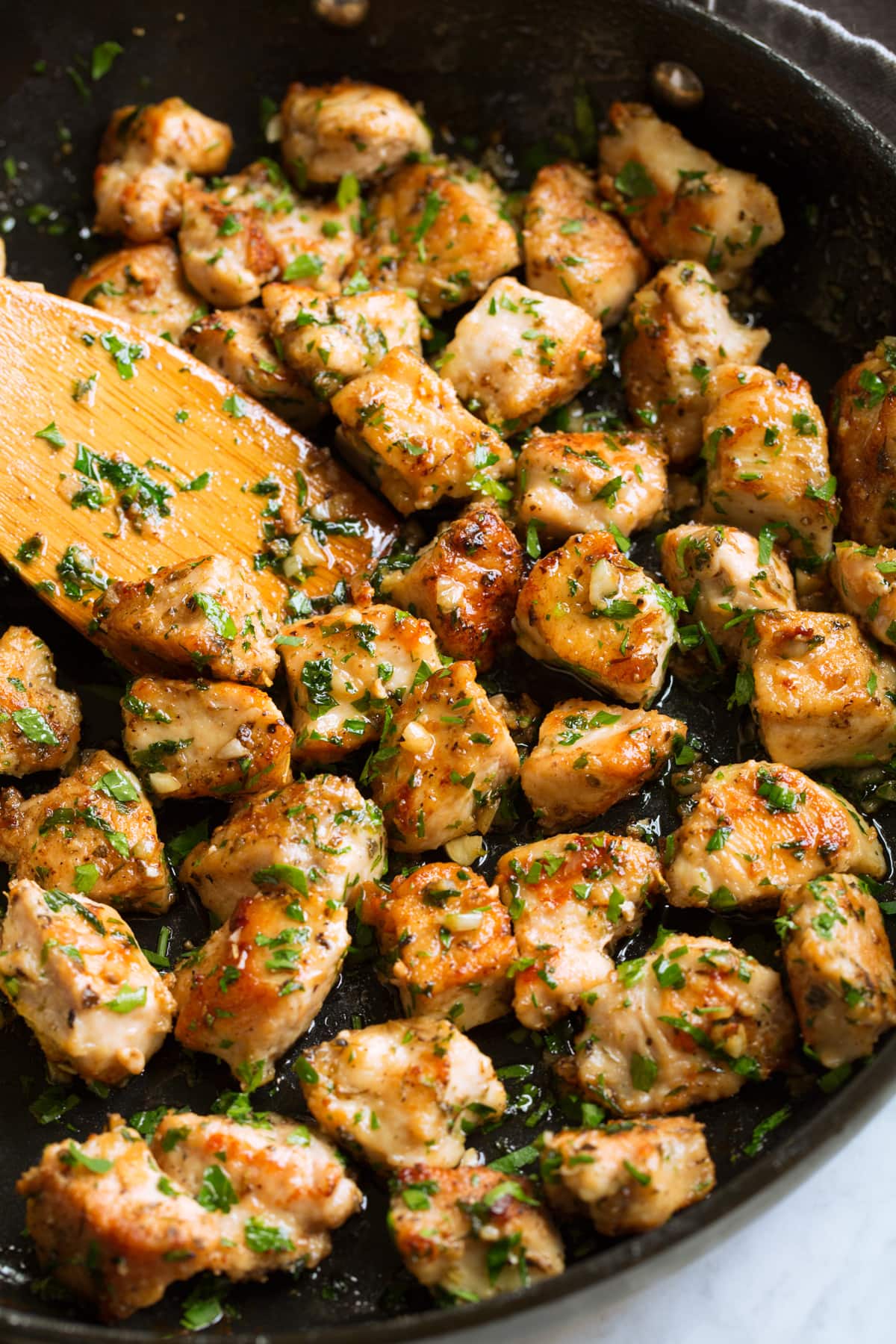 Garlic Butter Chicken Bites Chicken bites in a skillet with garlic and butter sauce.