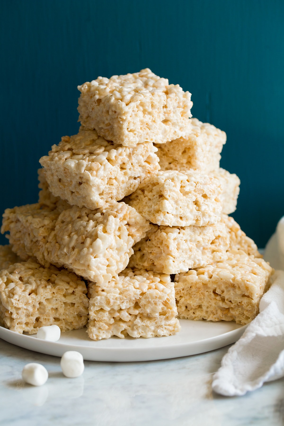 Rice Krispie Treats Stack of cut rice krispie treats on a platter.