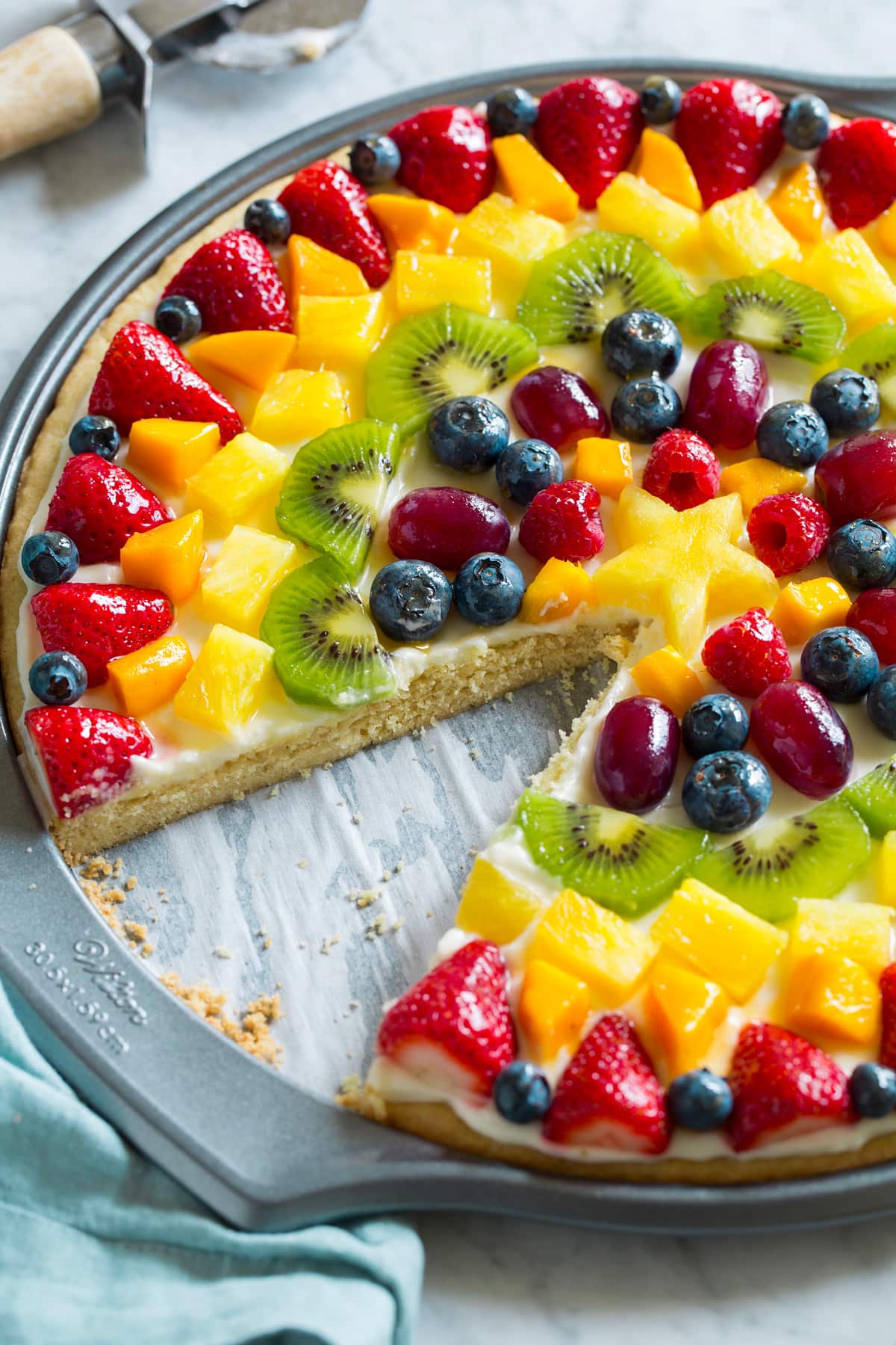 Fruit Pizza Side view of fruit pizza with one slice removed to show texture of interior.
