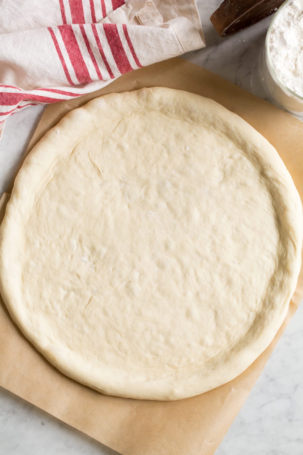 Homemade Pizza Dough Overhead image of shaped pizza crust without toppings.