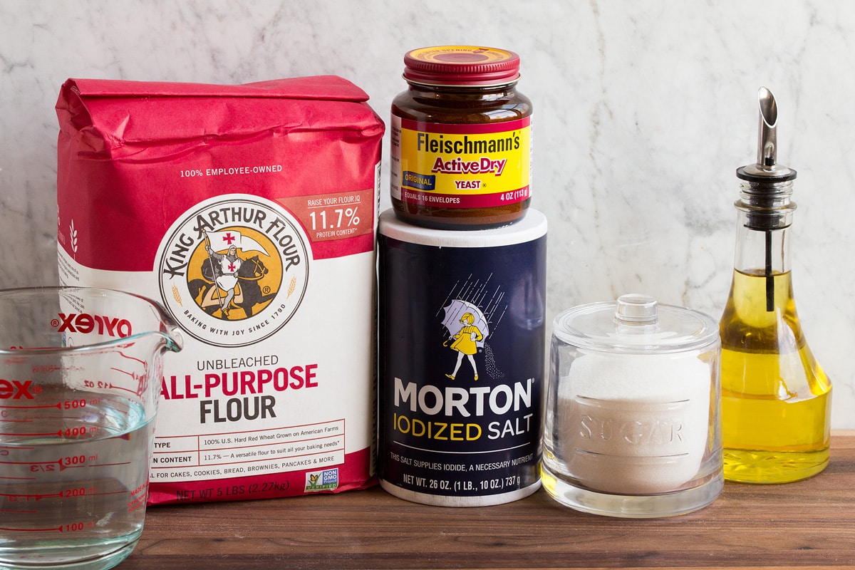 Homemade Pizza Dough Image of ingredients used to make pizza dough. Includes all-purpose flour, water, salt, yeast, sugar and olive oil.