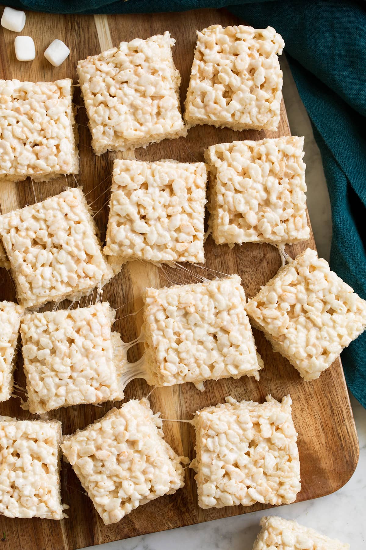 Best Rice Krispie Treats Overhead image of rice krispie treat squares on a wooden cutting board.