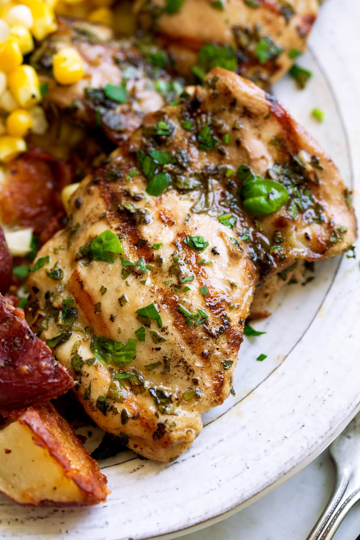 Garlic Herb Grilled Chicken Close up image of single grilled chicken thigh.