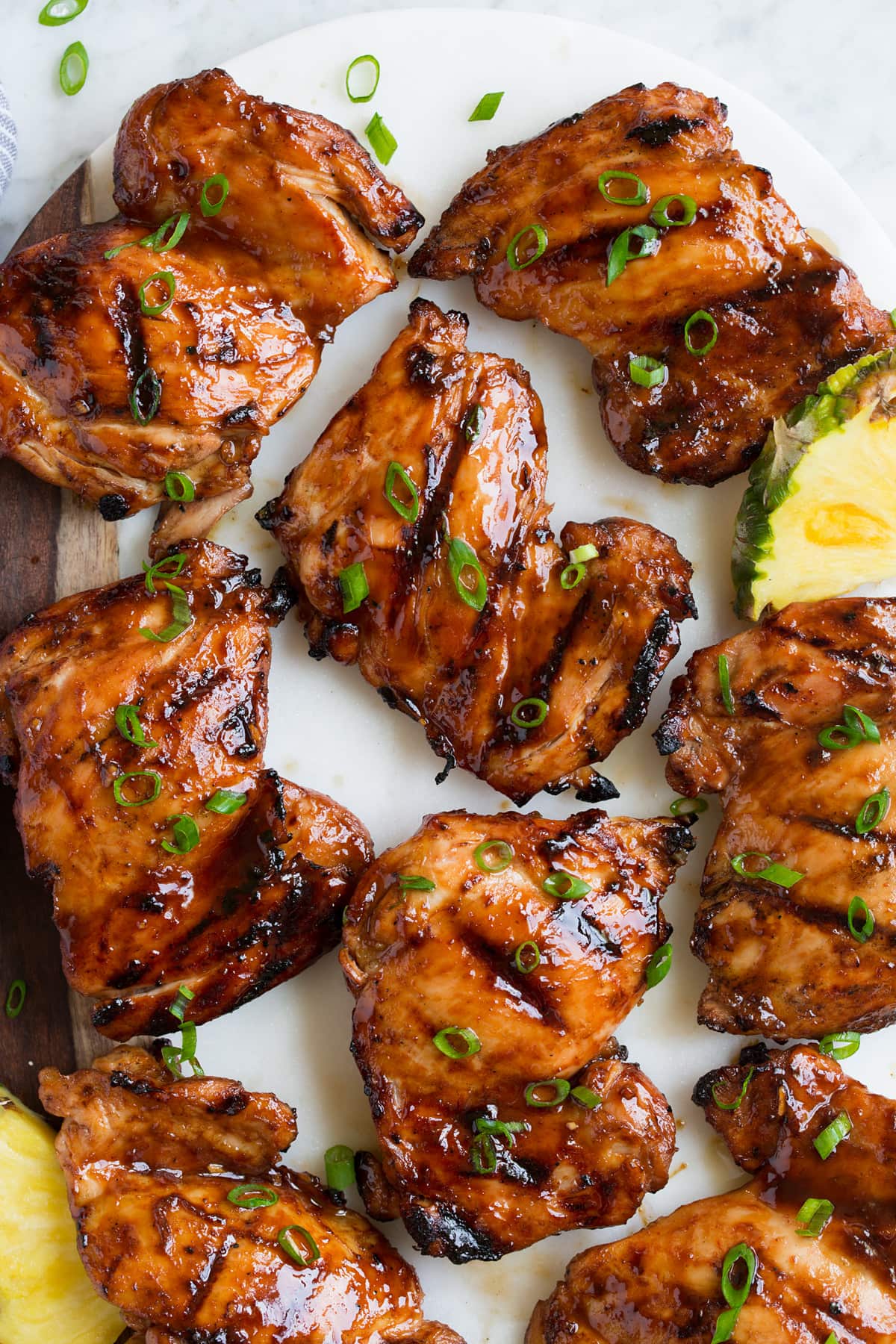 Huli Huli Chicken Close up image of huli huli chicken thighs on a platter. Shown overhead.