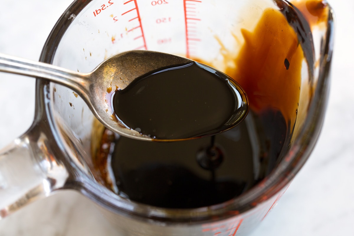 Caprese Salad Balsamic glaze shown in a spoon after reduced and thickened.