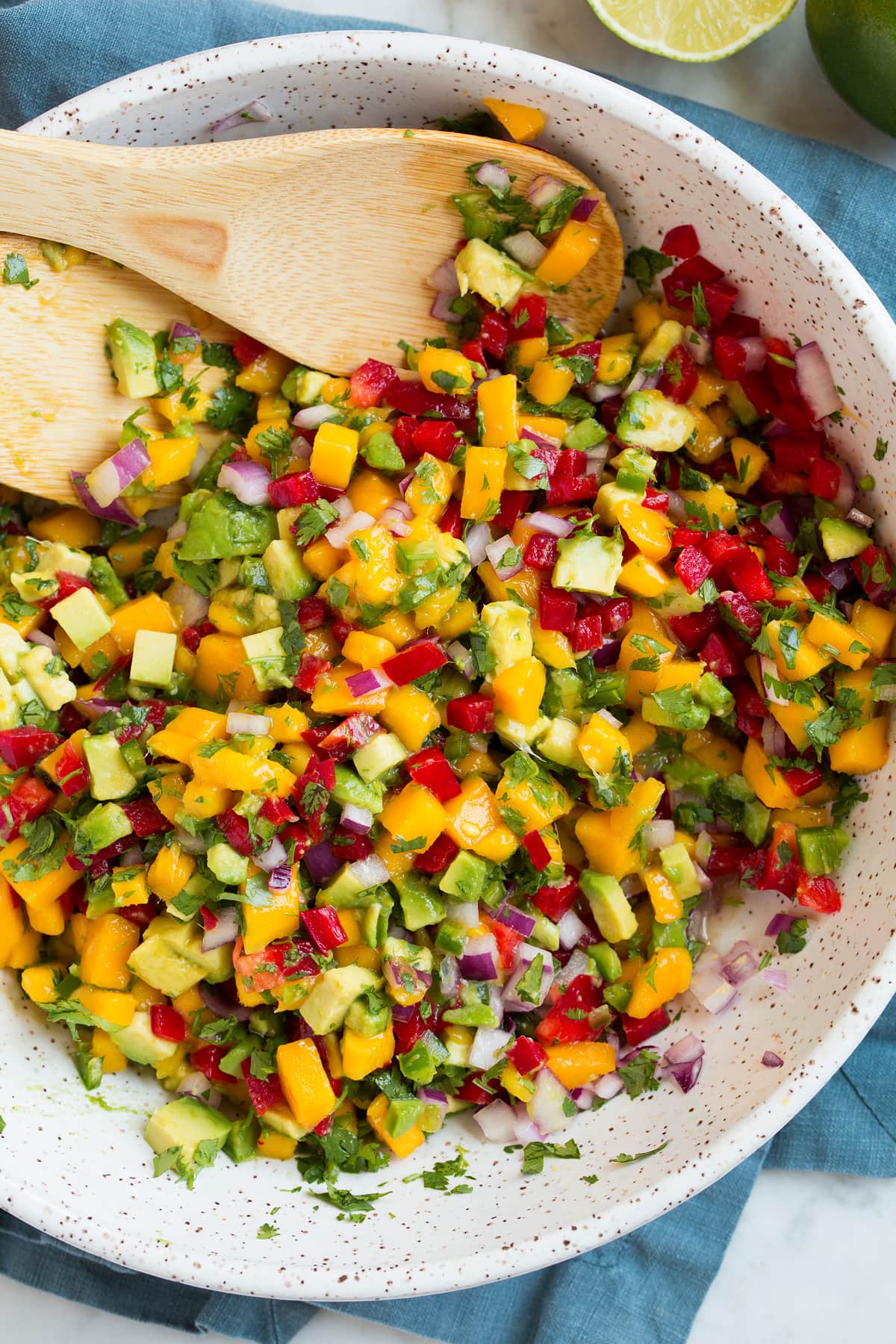 Mango Salsa (with Avocado!) Close up image of mango salsa shown after tossing ingredients.
