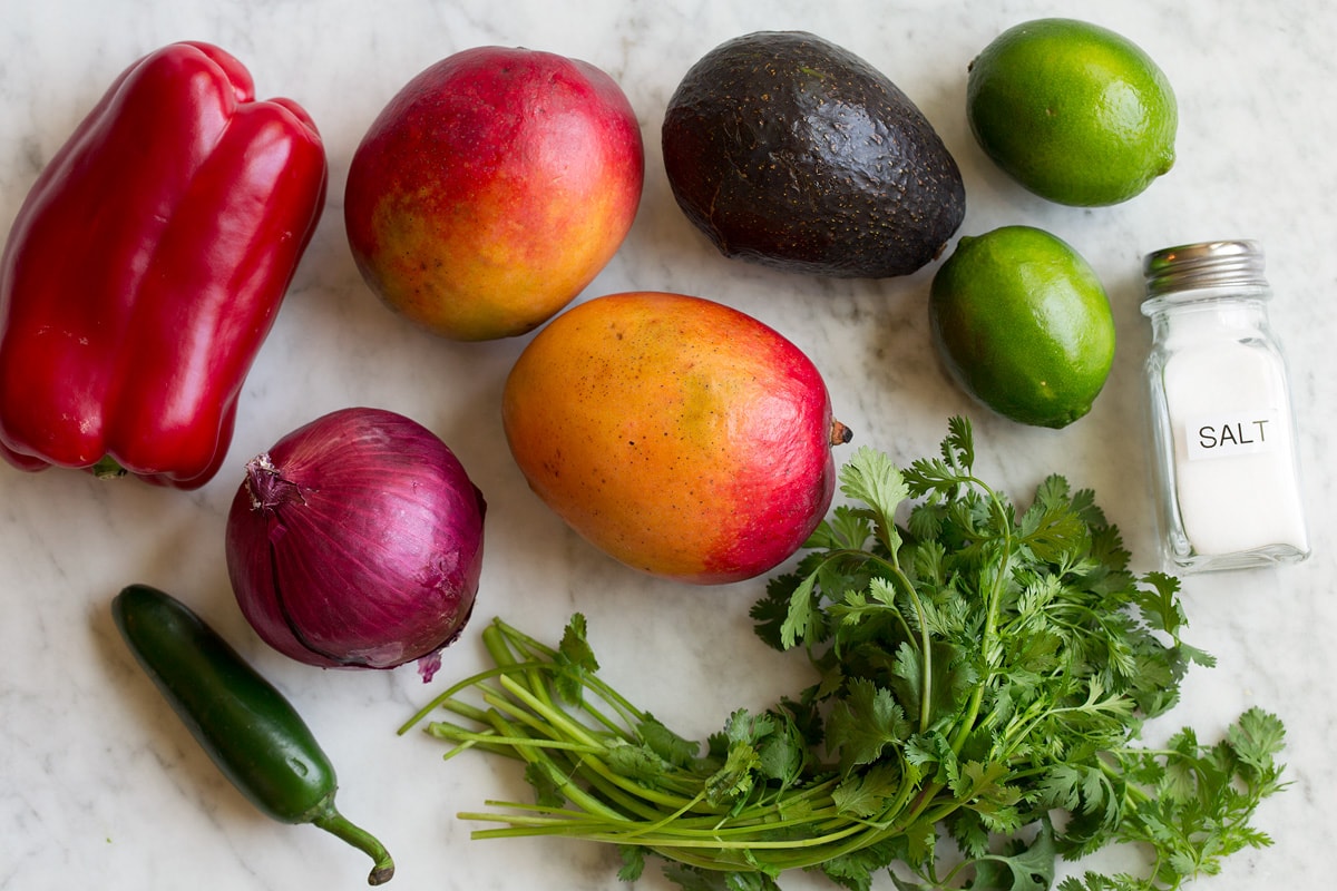 Mango Salsa (with Avocado!) Image of ingredients used in mango salsa. Includes fresh mangoes, avocado, bell pepper, cilantro, red onion, lime, jalapeno and salt.