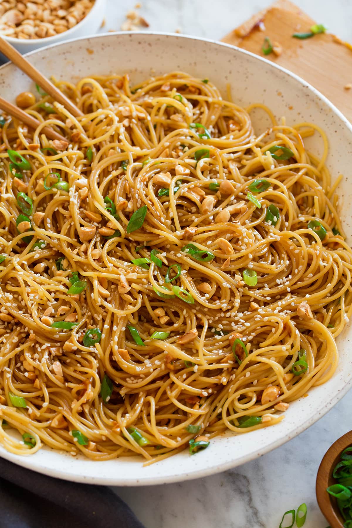Sesame Noodles Photo: Sesame noodles shown from the side in a large white ceramic serving bowl.