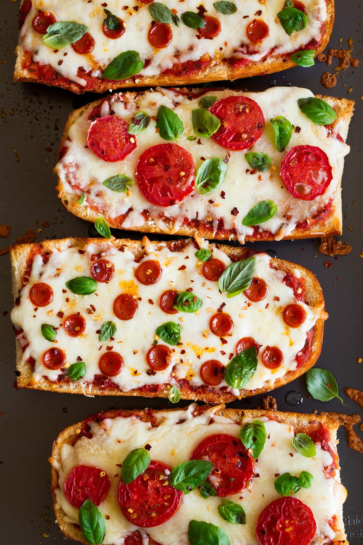 French Bread Pizzas Close up image of four big slices of french bread pizza.