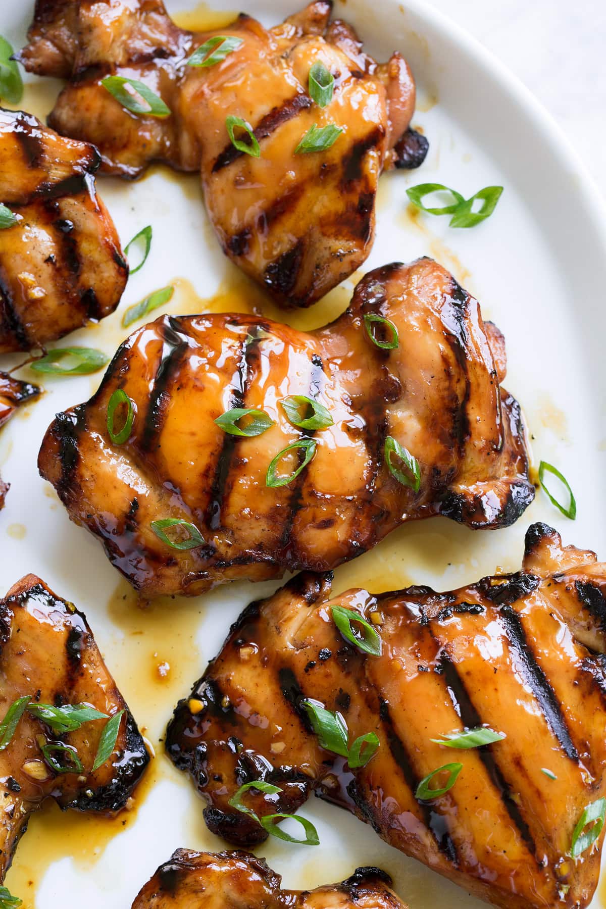 Marinated Grilled Teriyaki Chicken Close up image of marinated grilled teriyaki chicken thighs.