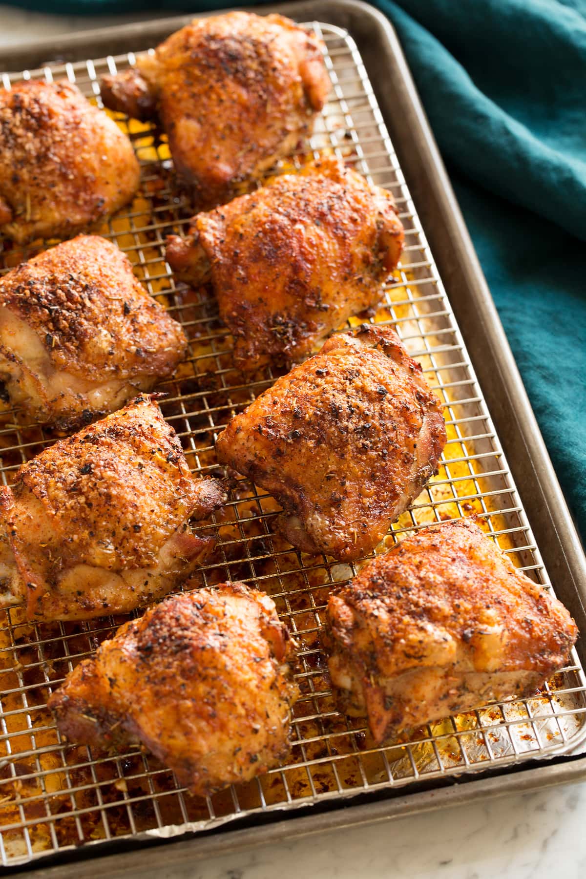 Baked Chicken Thighs Chicken thighs on wire rack shown after baking.