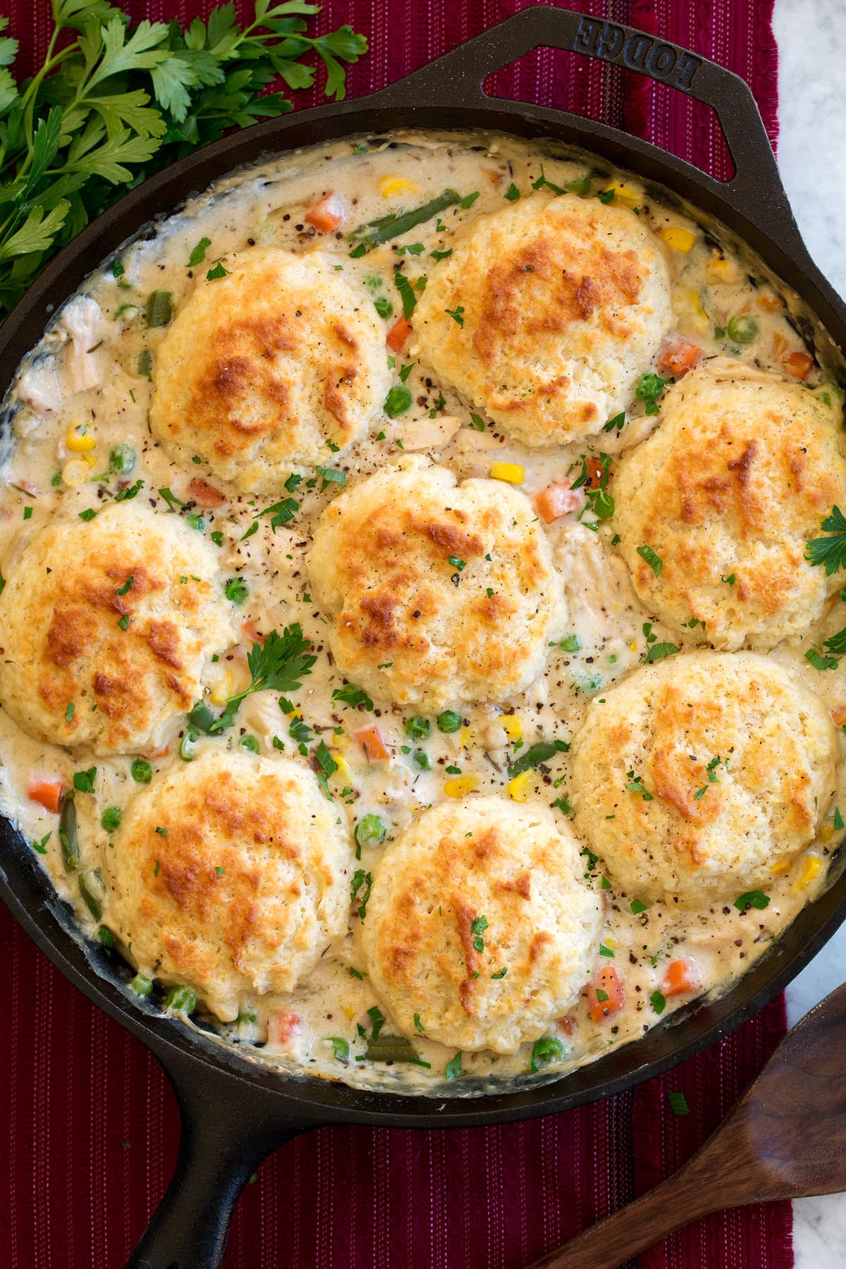 Chicken Pot Pie with Biscuits Overhead image of chicken pot pie with biscuits shown in a cast iron skillet after baking and finished.