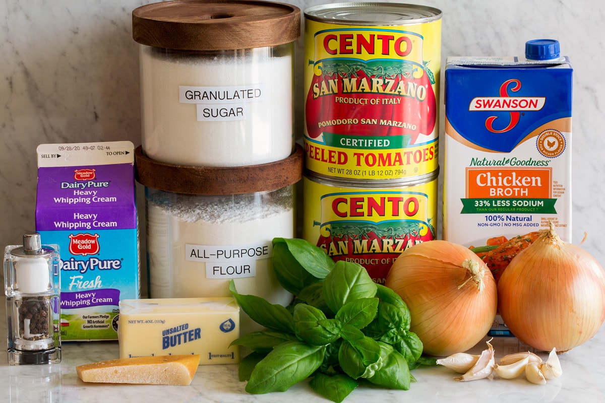 Homemade Tomato Soup Image of ingredients used to make homemade tomato soup. Includes canned san marzano tomatoes, chicken broth, onions, garlic, basil, flour, sugar, butter, parmesan rind, cream, salt and pepper.