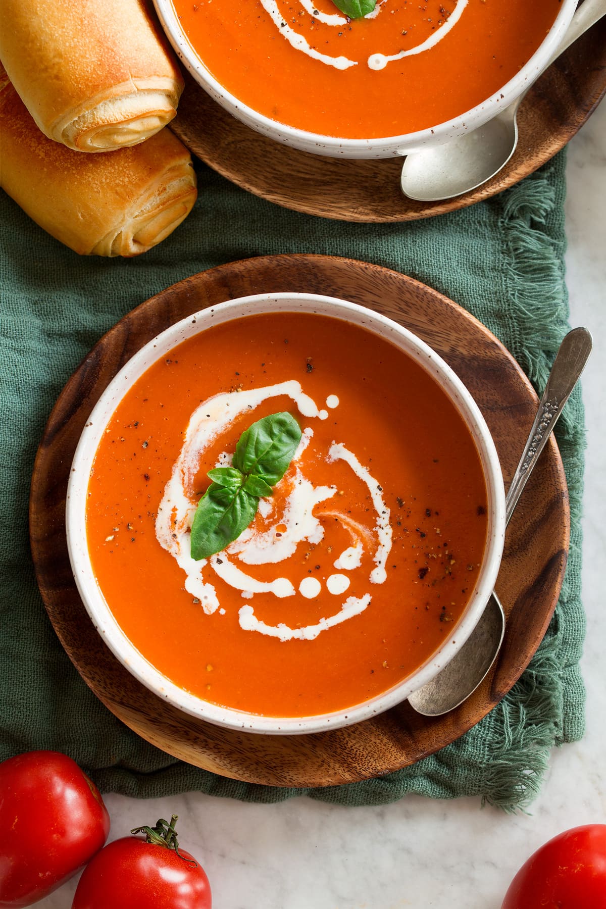 Homemade Tomato Soup Overhead image of serving of tomato soup swirled with heavy cream.