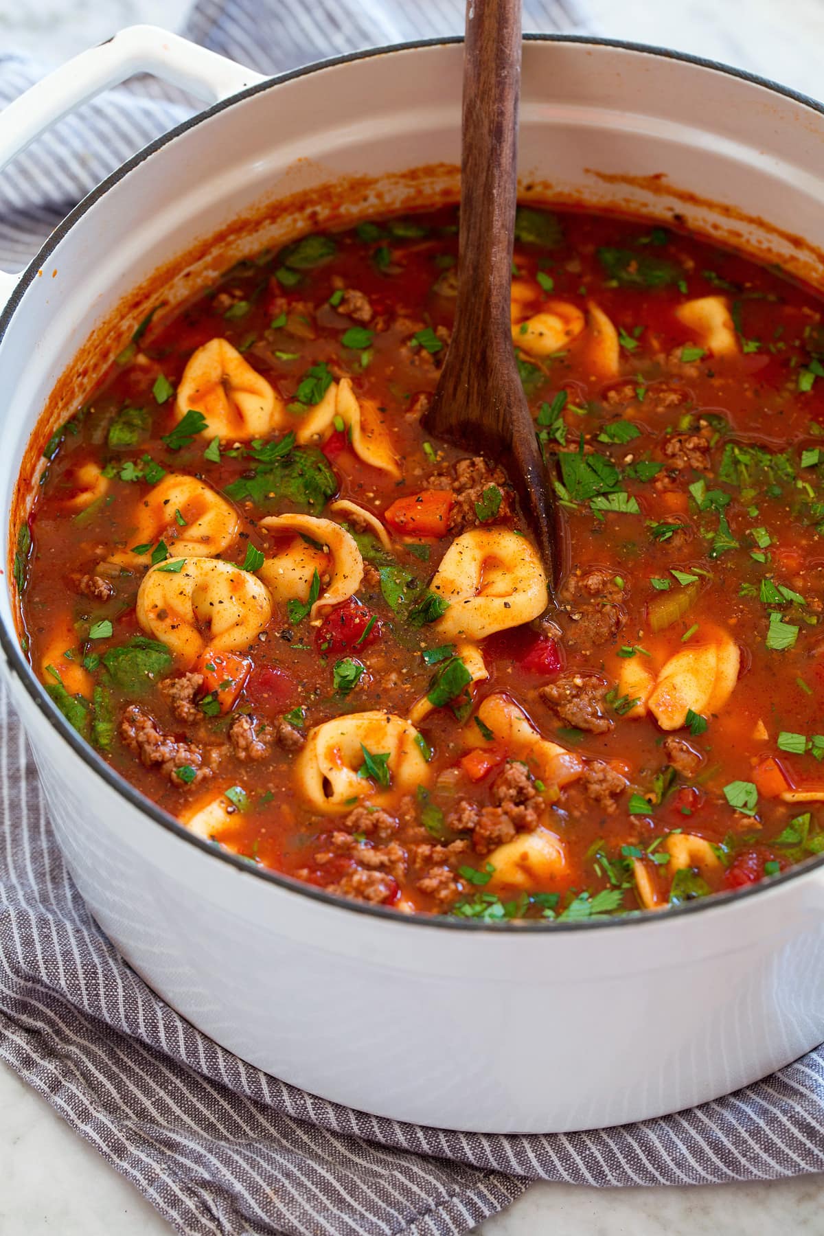Tortellini Soup White pot full of tortellini soup.