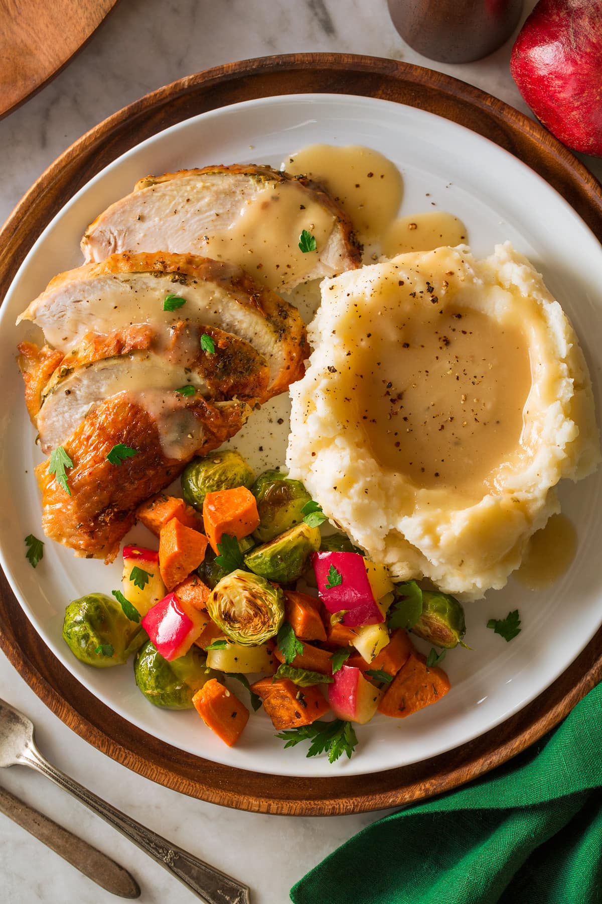 Roast Turkey Breast Roast Turkey Breast on a platter with a side of mashed potatoes and roasted vegetables.