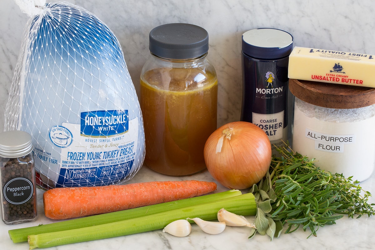 Roast Turkey Breast Image of ingredients used to make Roast Turkey Breast and gravy. Shows turkey breast in packaging, broth, salt, pepper, butter, herbs, onions, carrot, celery and garlic.