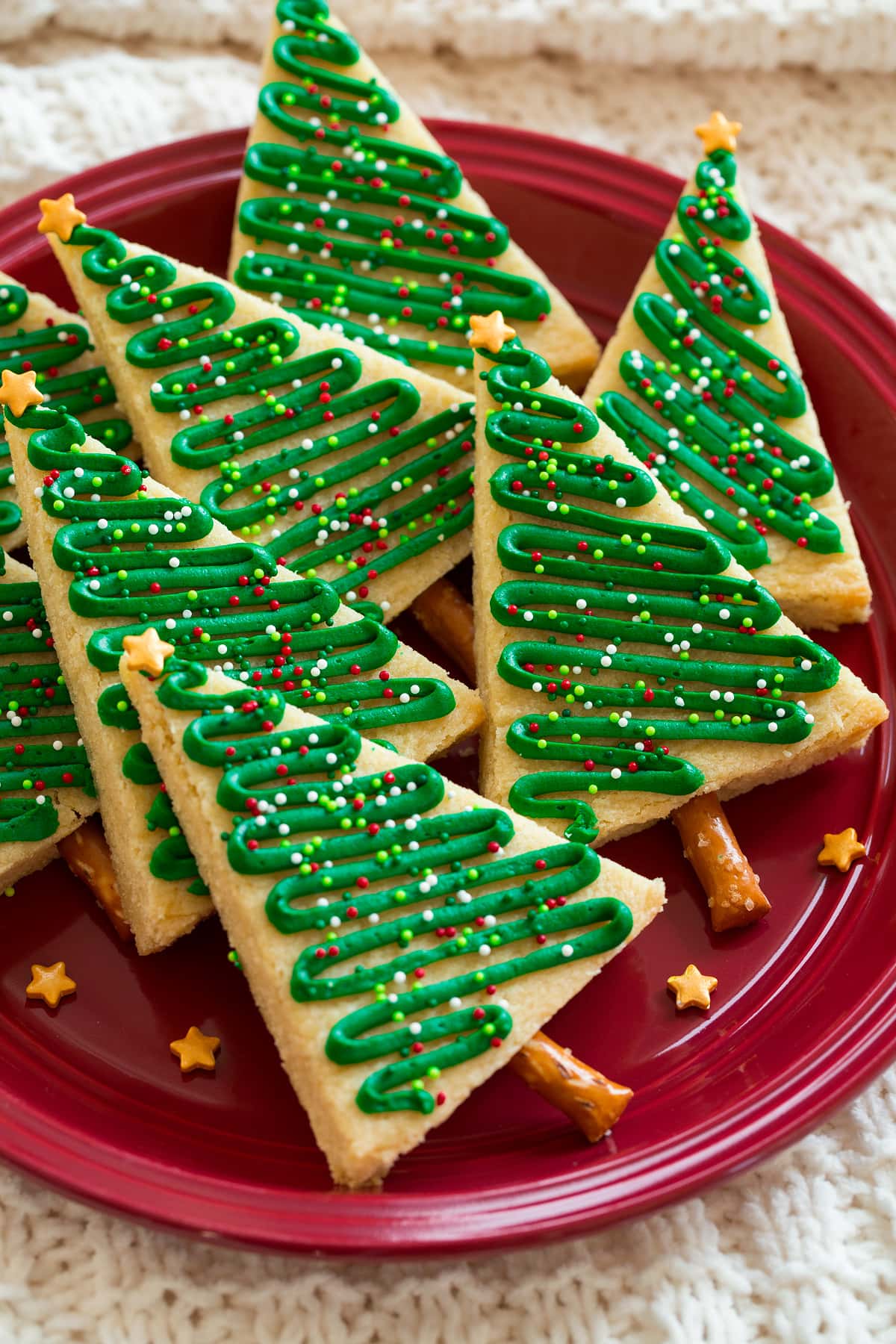 Christmas Tree Cookies Christmas tree cookies shown on a red plate.