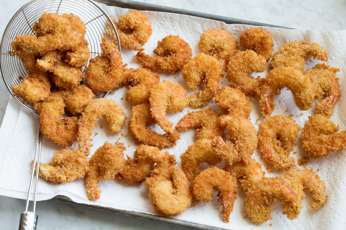 Fried Shrimp Photo of fried shrimp after frying on a paper towel lined baking sheet.