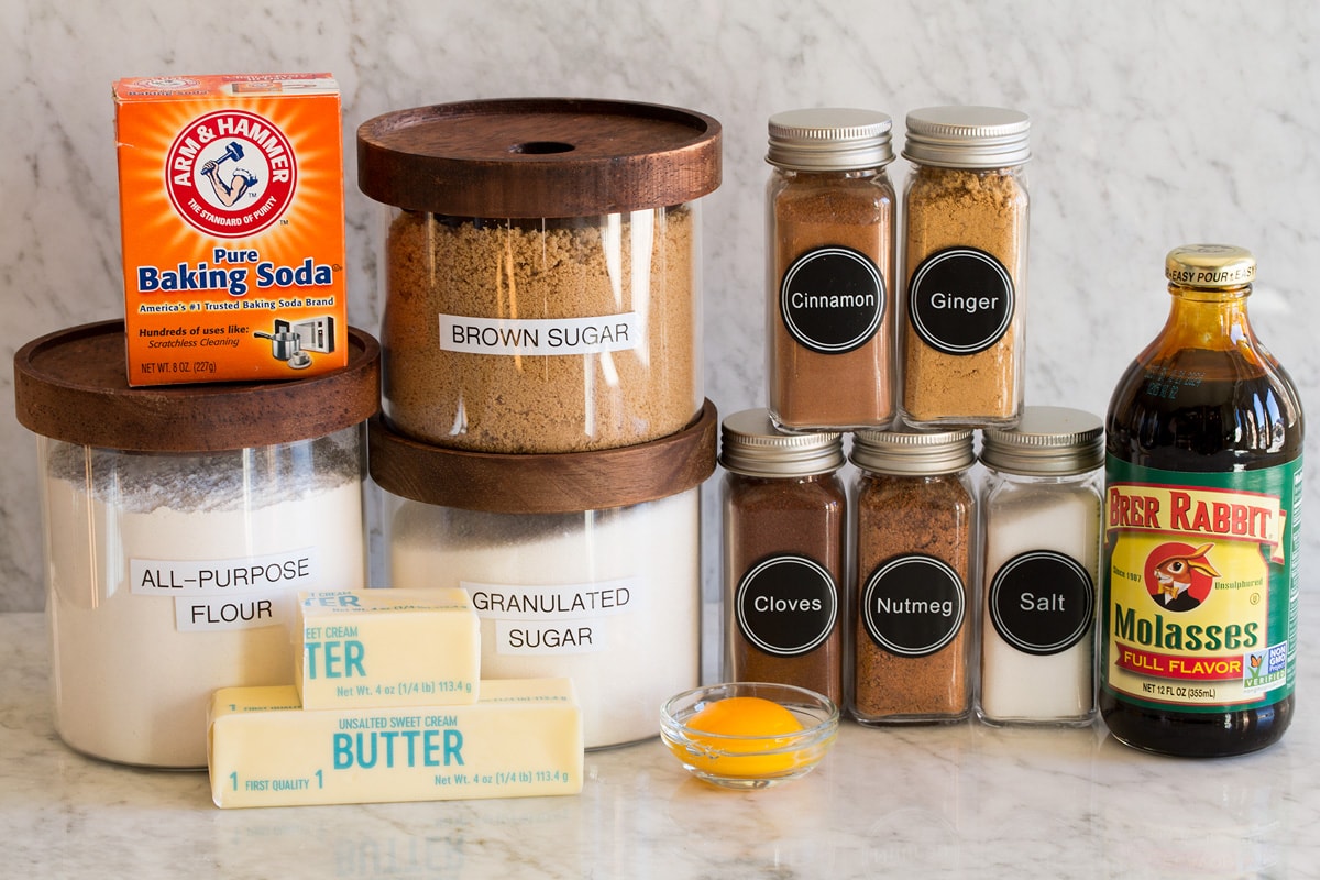 Molasses Cookies Image of ingredients used to make molasses cookies. Includes flour, sugar, molasses, brown sugar, baking soda, salt, egg yolk, butter, cinnamon, nutmeg, ginger, and cloves.