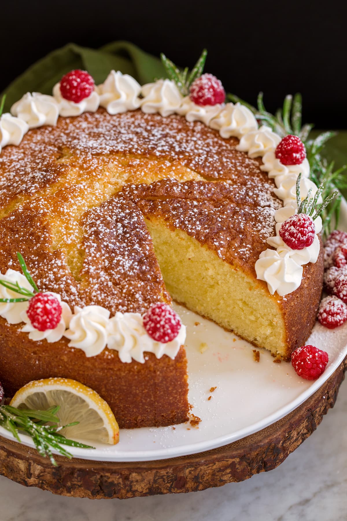 Olive Oil Cake Photo of whole olive oil cake with one slice removed.